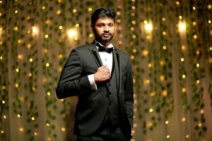 Elegant portrait of a stylish man in a black suit with a captivating bokeh background.